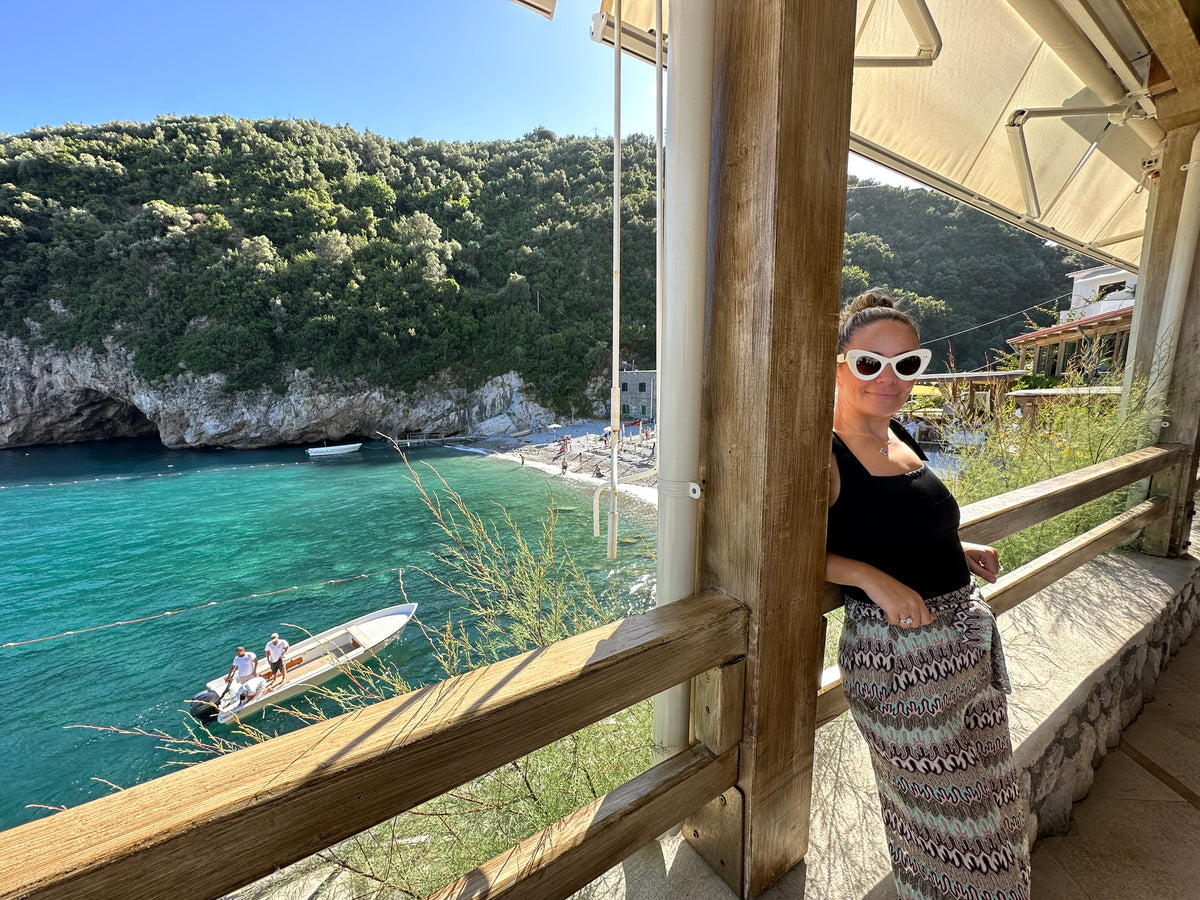 Founder natalie in Italy by the sea, her happy place.